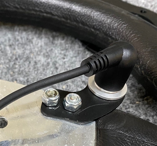 Close-up of the push-to-talk button bolted through the steering wheel spoke