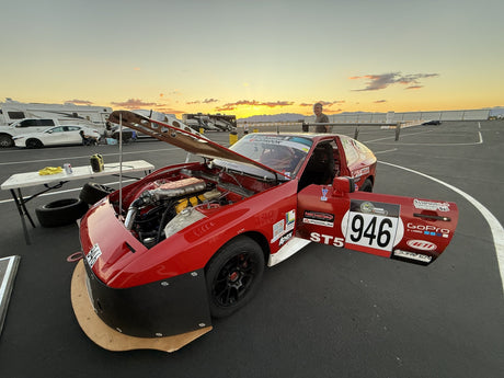 Slowdog Racing's red number 946 endurance race car at sunset in the Chuckwalla Valley Raceway paddock during the Lucky Dog Racing League Wild Dawgs weekend