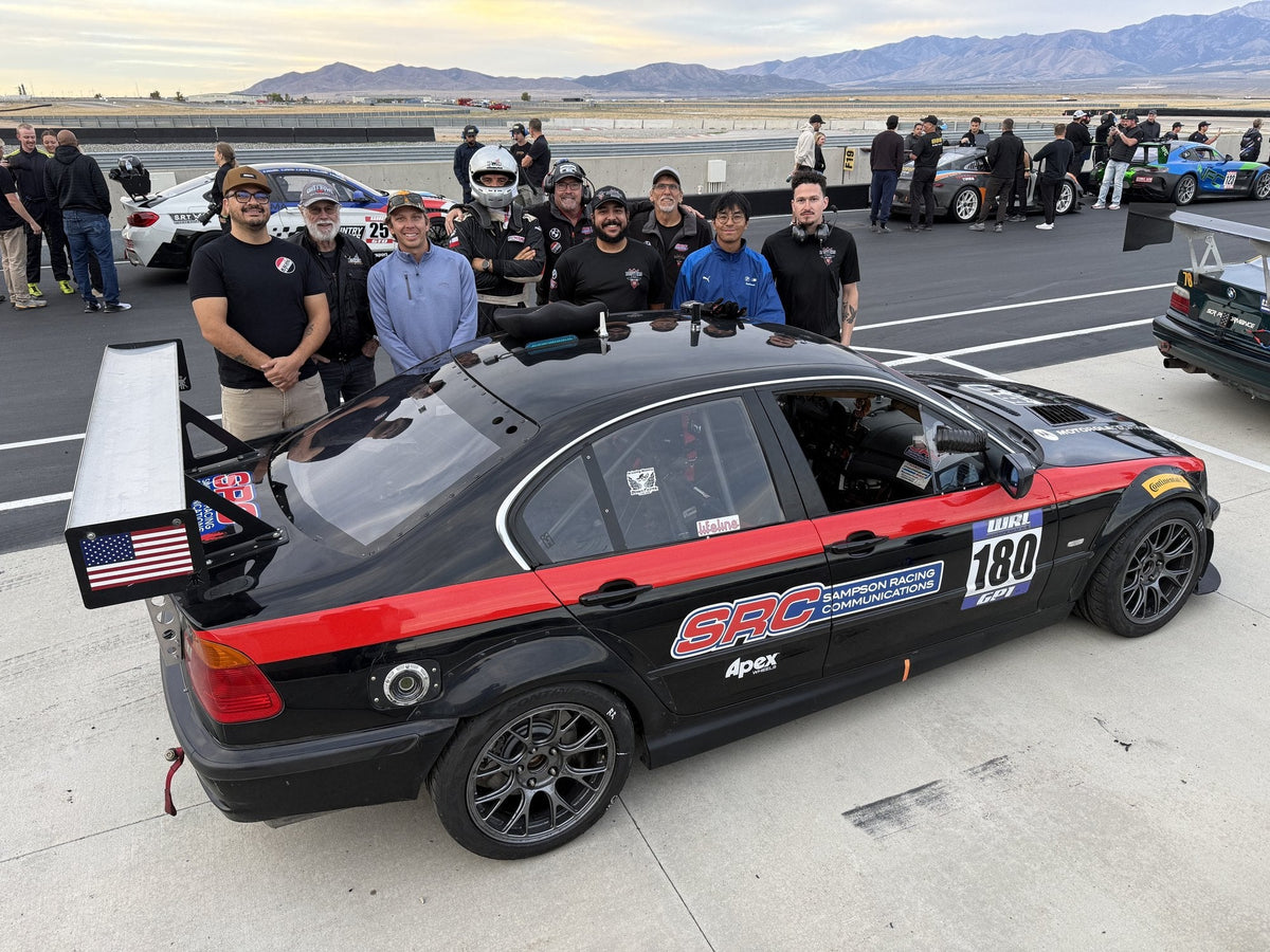 The SoCal Rustlers and SRC crew with the number 180 GP1 BMW E46 on pit lane at Utah Motorsports Campus after the World Racing League weekend